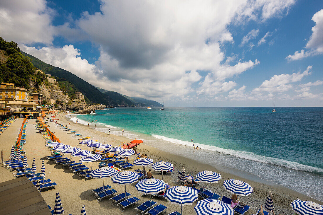 Sandy beach and colorful sunshades, Monterosso al Mare, Cinque Terre, La Spezia Province, Liguria, Italy