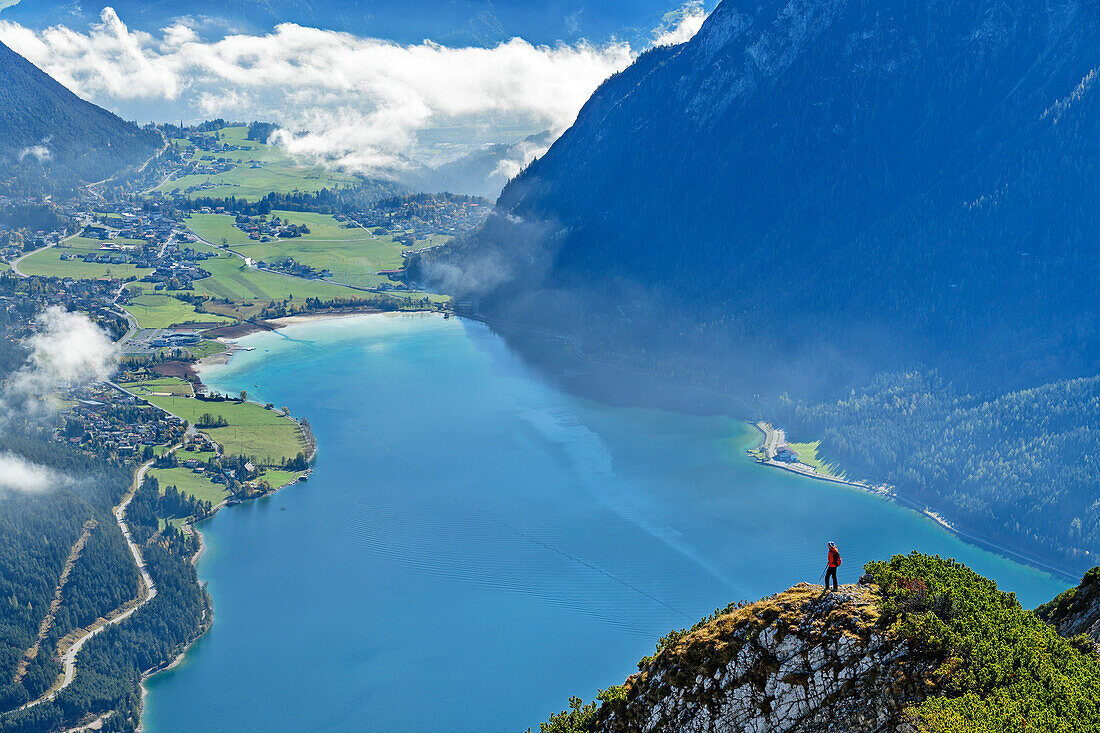 Woman hiking looking towards lake Achensee, from Seebergspitze, Karwendel range, Tyrol, Austria