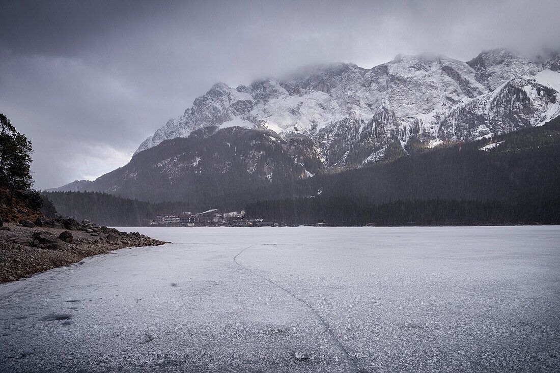 snowfall at frozen Eibsee lake below Zugspitze mountain, Grainau community, Garmisch-Partenkirchen, Bavaria, Alps, Germany