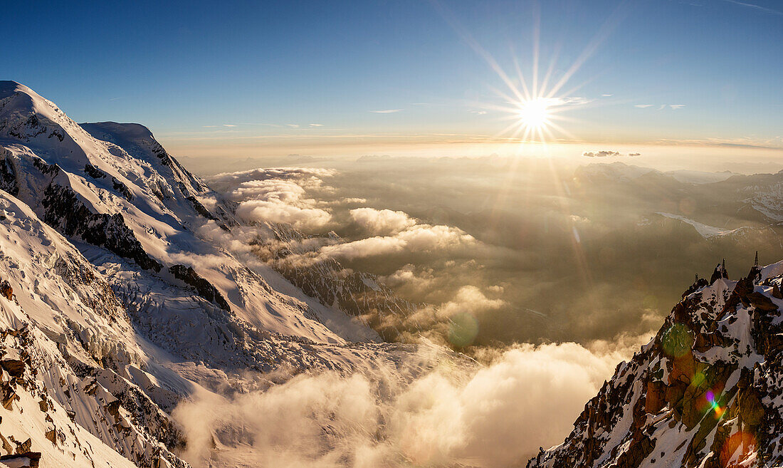 Sunset over the valley of Chamonix, sea of clouds and fog, view from Cosmiques hut, Chamonix, Haute-Savoie, France