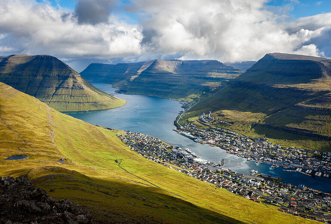 The village of Klaksvík by a fjord, surrounded by mountains with beautiful weather, Faroe Islands