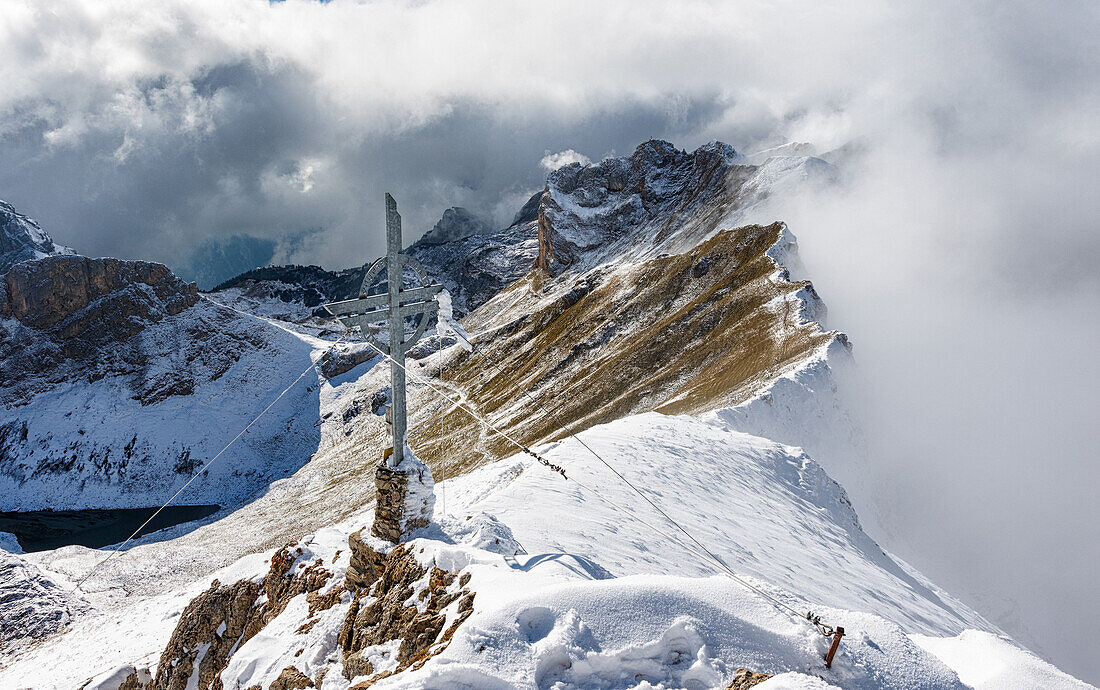Summit of mount Rofanspitze after the first snowfall with mystery clouds, Rofan, Tyrol, Austria