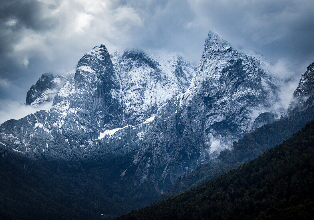 North faces of Wilder Kaiser after the first snowfall with dramatic clouds, Kaiserbachtal, Wilder Kaiser, Tyrol, Austria