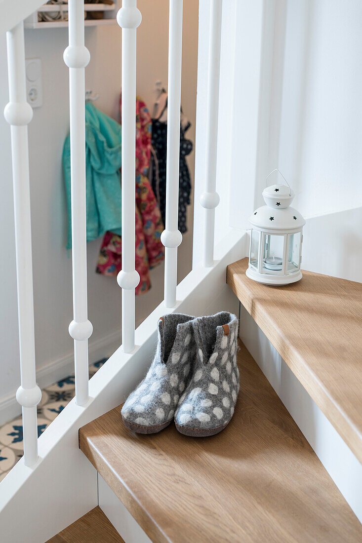 Staircase with slippers in family house with wooden steps and white railing, Korbach, Hesse, Germany, Europe