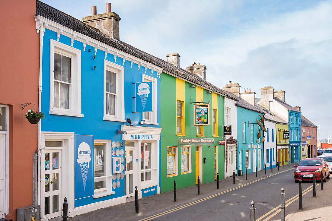 Colourful houses on Strand Street, the blue one featuring the popular Murphy’s ice cream shop seen from while walking the Dingle Way, Dingle, Dingle Peninsula, County Kerry, Ireland, Europe