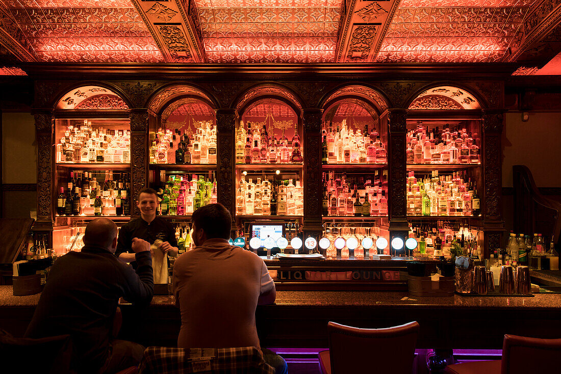 Bar with a view: Rows and rows of whiskeys, gins and other alcoholic beverages grace the first floor of the Dail Bar in the city center, Galway, County Galway, Ireland, Europe