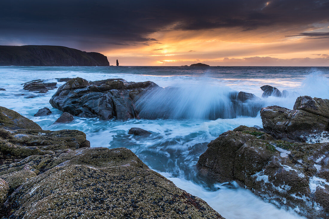 Sunset at Sandwood Bay, spray splashes over rocks, Highlands, Scotland, UK