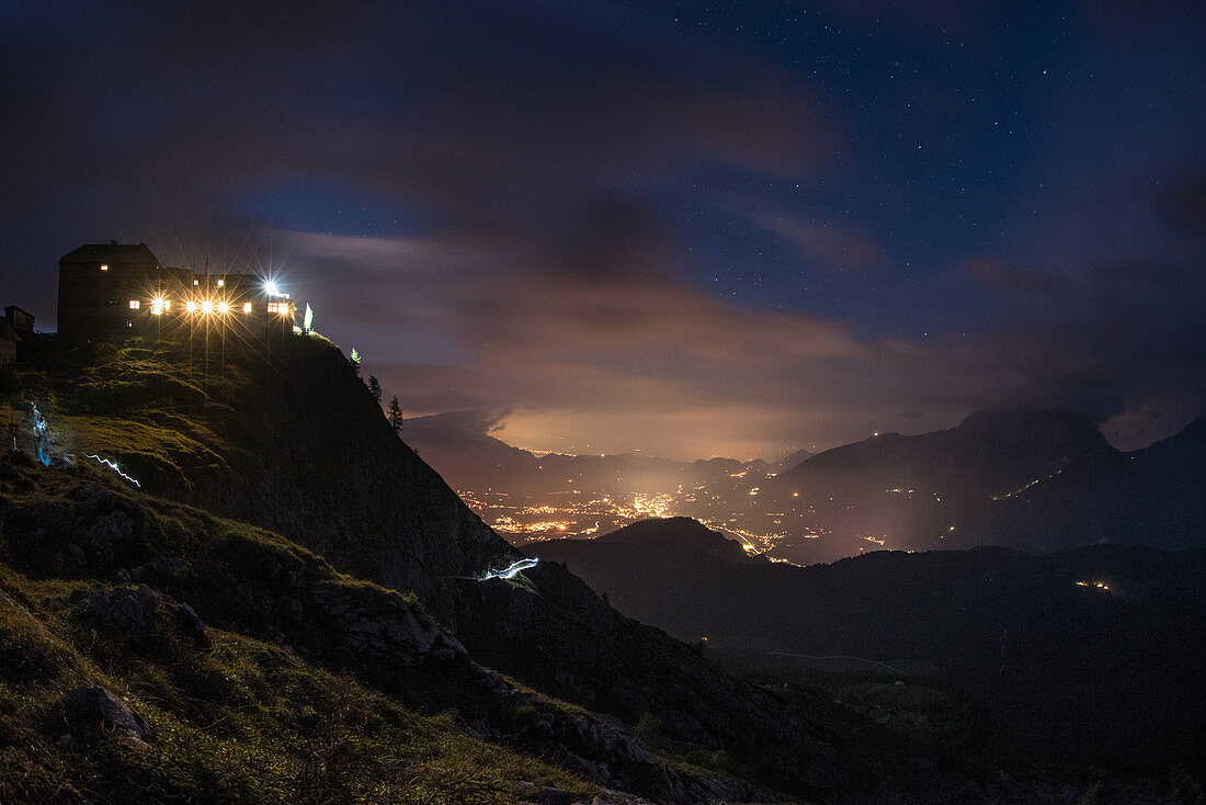Arrival at the Watzmannhaus at dusk, view of the valley and city lights, Berchtesgaden Alps, Berchtesgaden, Germany