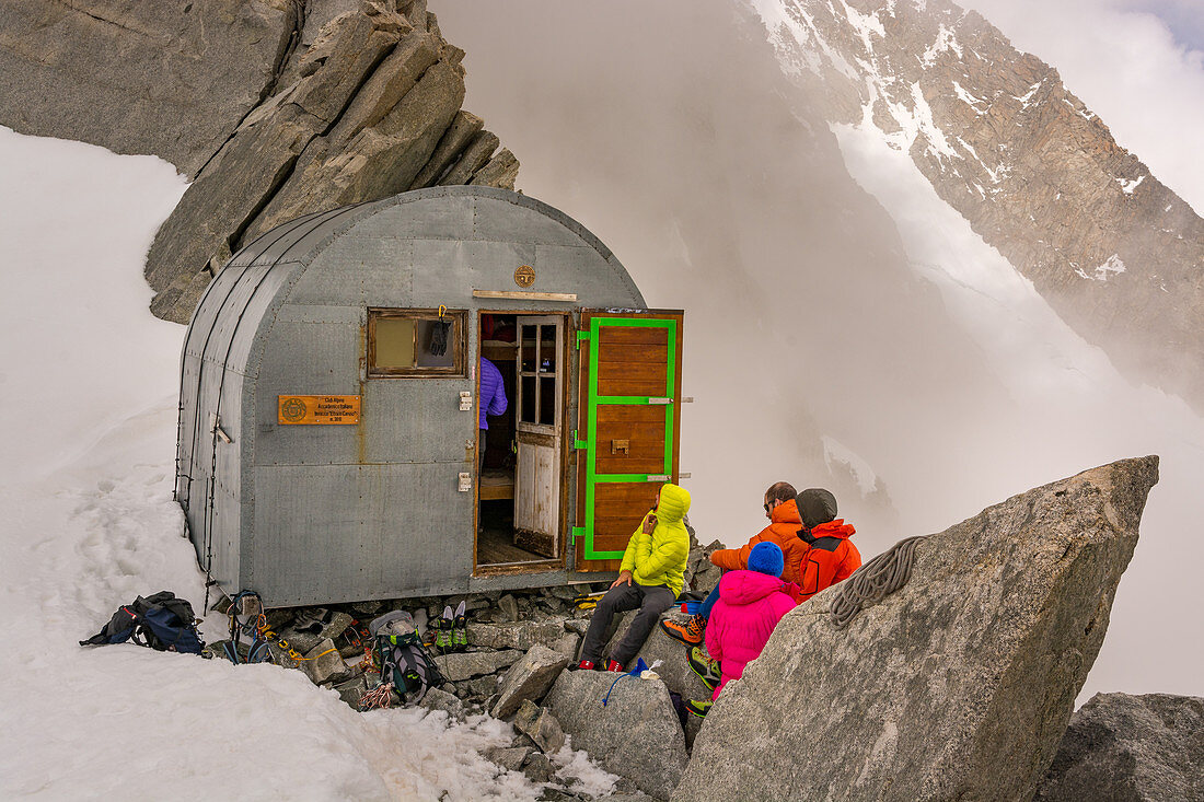 Climbers in front of the bivouac Ettore Canzio, Grandes Jorasses, Mont Blanc group, France