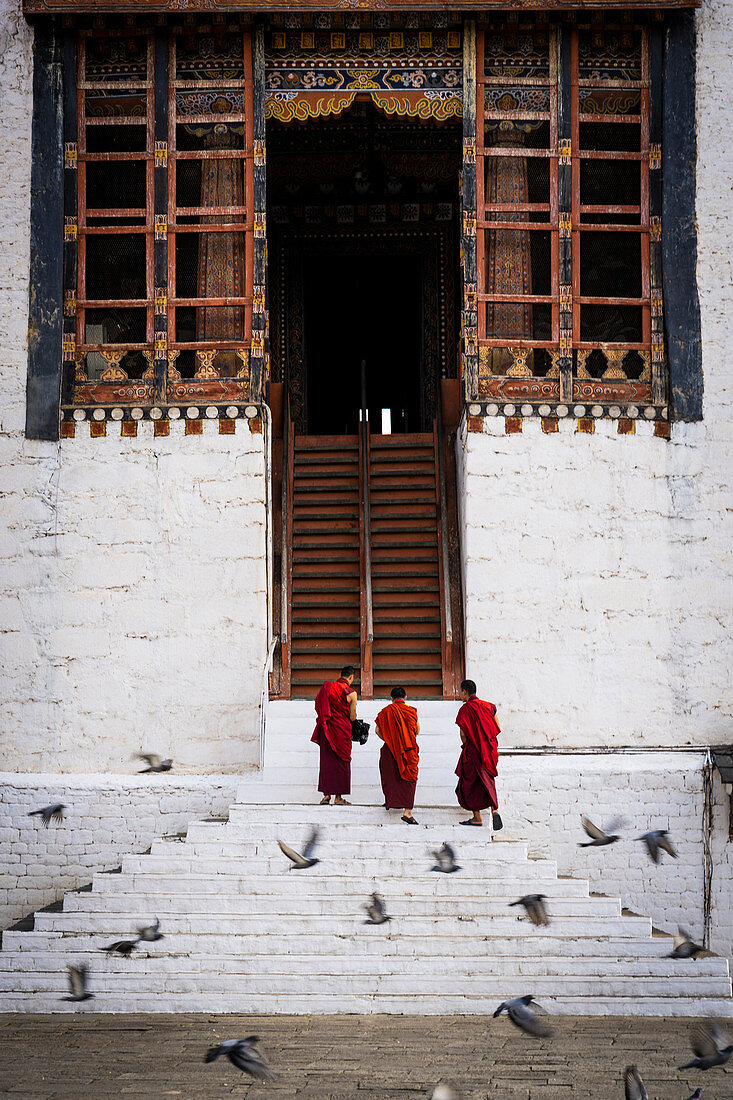 Monks at the Tashichho Dzong a Buddhist monastery and fortress on the northern edge of the city of Thimphu, Bhutan, Himalayan Country, Himalayas, Asia, Asian.