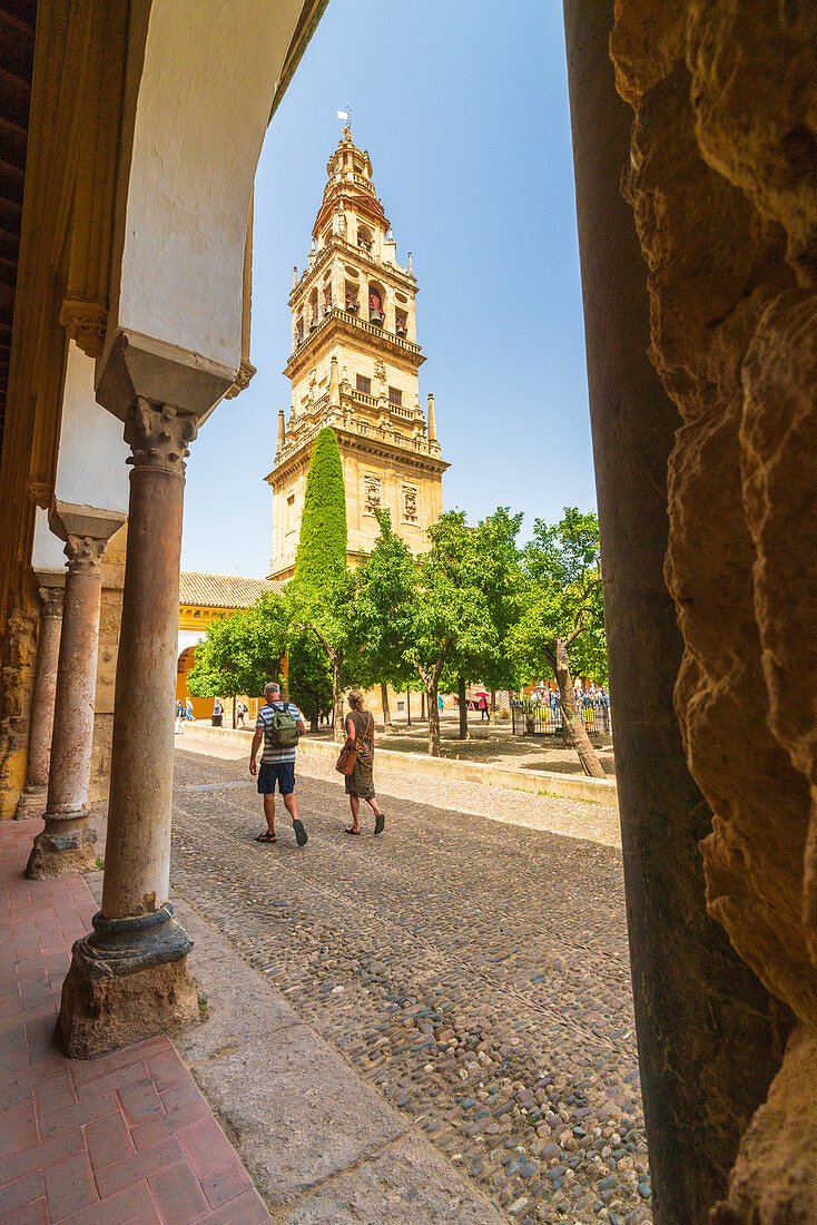 Tourists in the portico front of the tower of Mezquita-Catedral (Great Mosque of Cordoba), Cordoba, Andalusia, Spain