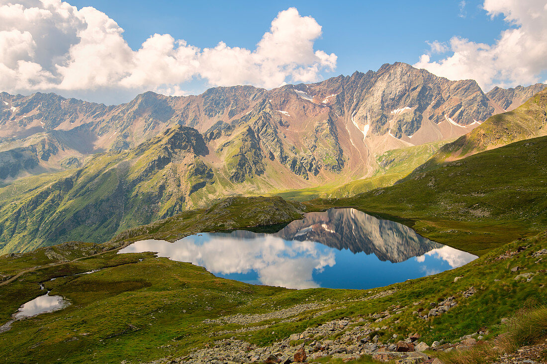 Pietrarossa reflected in the black lake, Gavia pass, Lombardy district, Italy, brescia province.