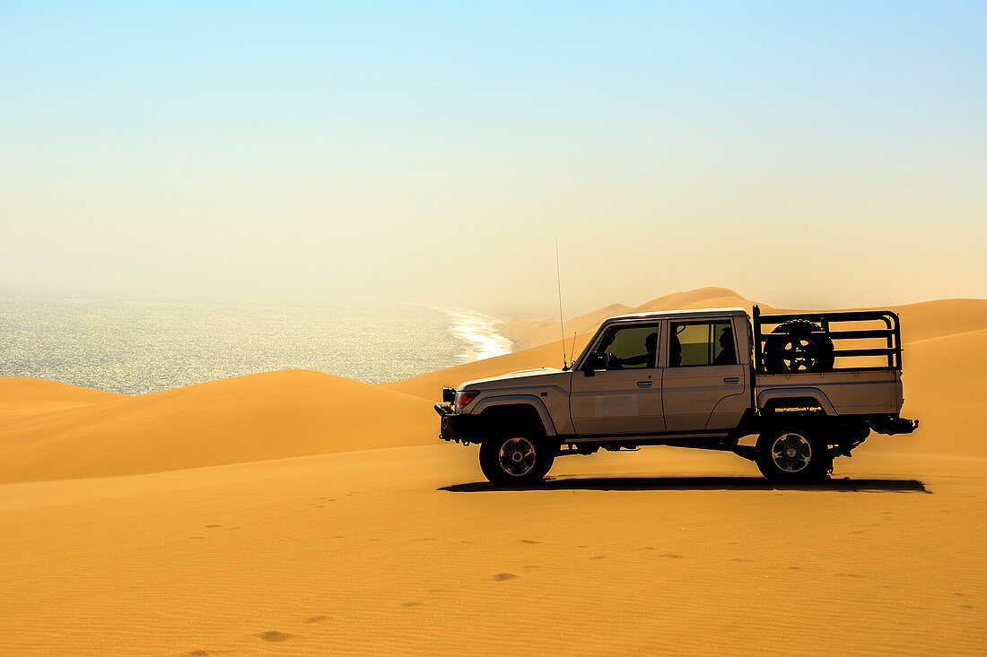 Offroad vehicle on top of the sand dunes,Sandwich Harbour, Namib Naukluft National Park,Namibia,Africa