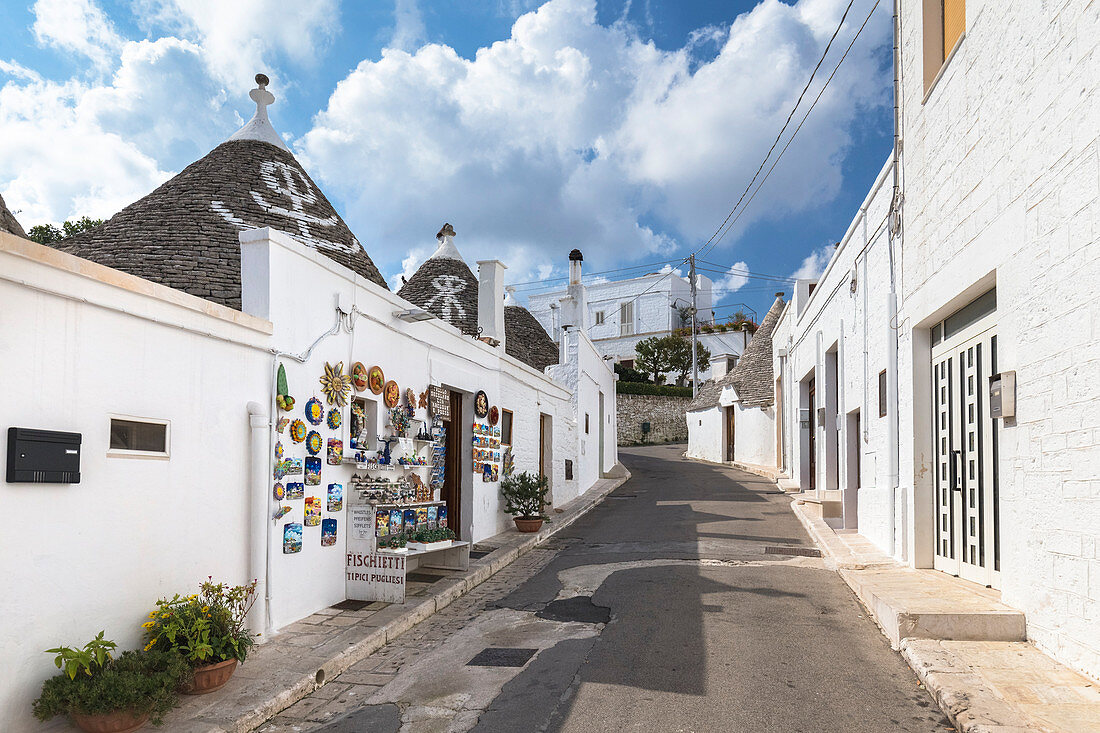 View of the typical Trulli huts and the alleys of the old village of Alberobello. Province of Bari, Apulia, Italy, Europe.