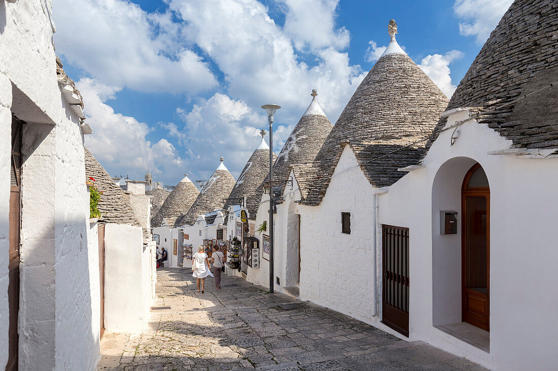 View of the typical Trulli huts and the alleys of the old village of Alberobello. Province of Bari, Apulia, Italy, Europe.