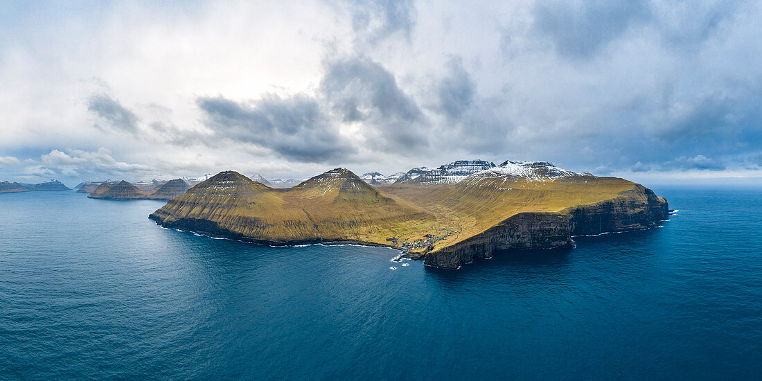 Aerial panoramic view of Eysturoy island from the sea in front of Gjogv village (Faroe Islands, Denmark)