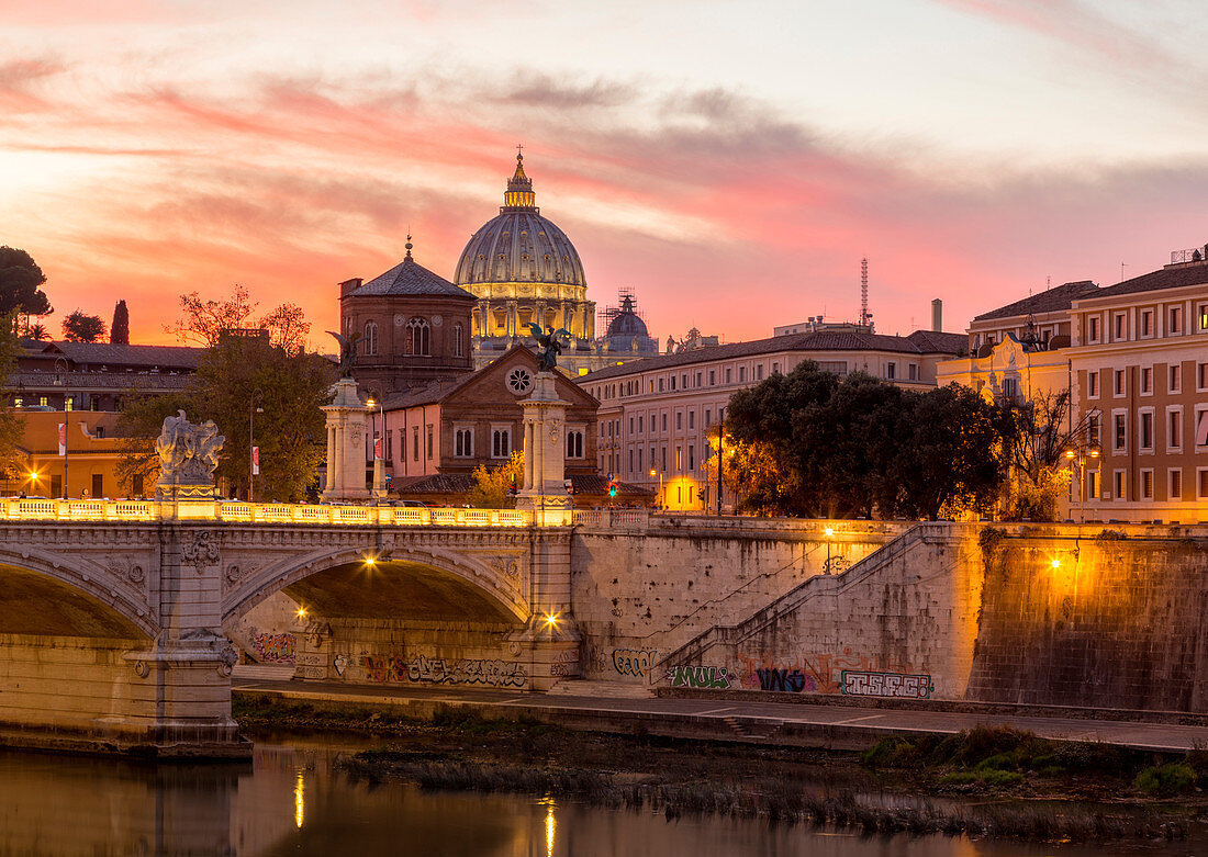 Rome at sunset with view of the dome of Saint Peter's Basilica, Octagonal Tower of the church of the holy spirit in the saxon district and Tiber River Europe, Italy, Lazio, Province of Rome, Rome, sunset