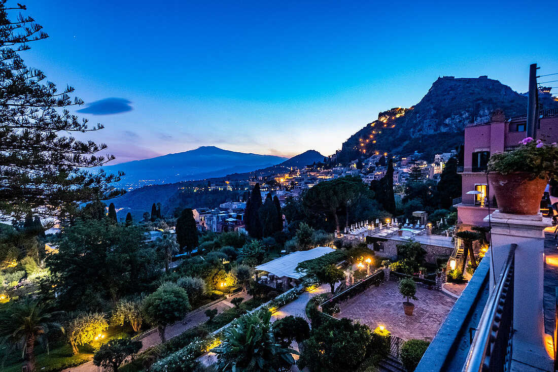 Sunset view from the terrace of the Grand Hotel Timeo to the volcano etna and Taormina, Sicily, South Italy, Italy