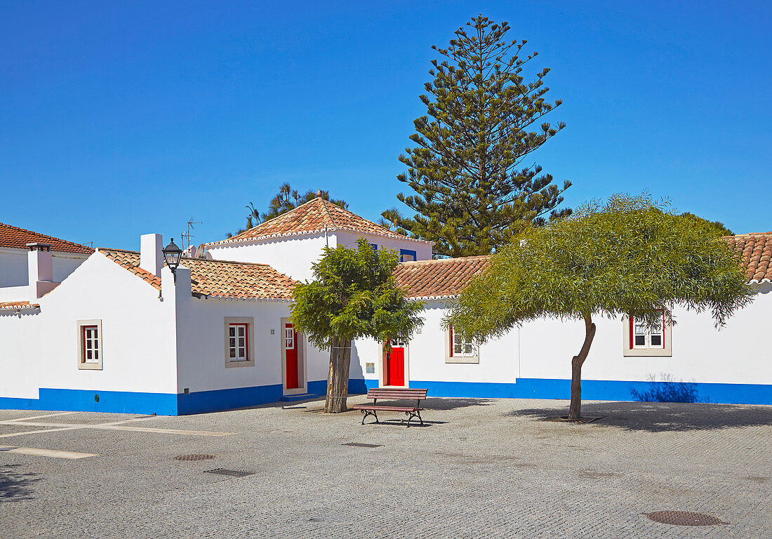 Weißes Haus mit roter Tür im Dorfzentrum von  Porto Covo, Distrikt Setubal, Alentejo, Portugal, Europa
