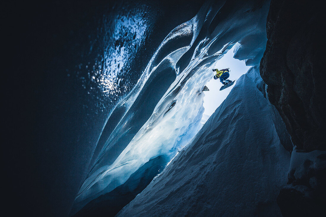 Snowboarder rides in an ice cave, Pitztal, Austria,