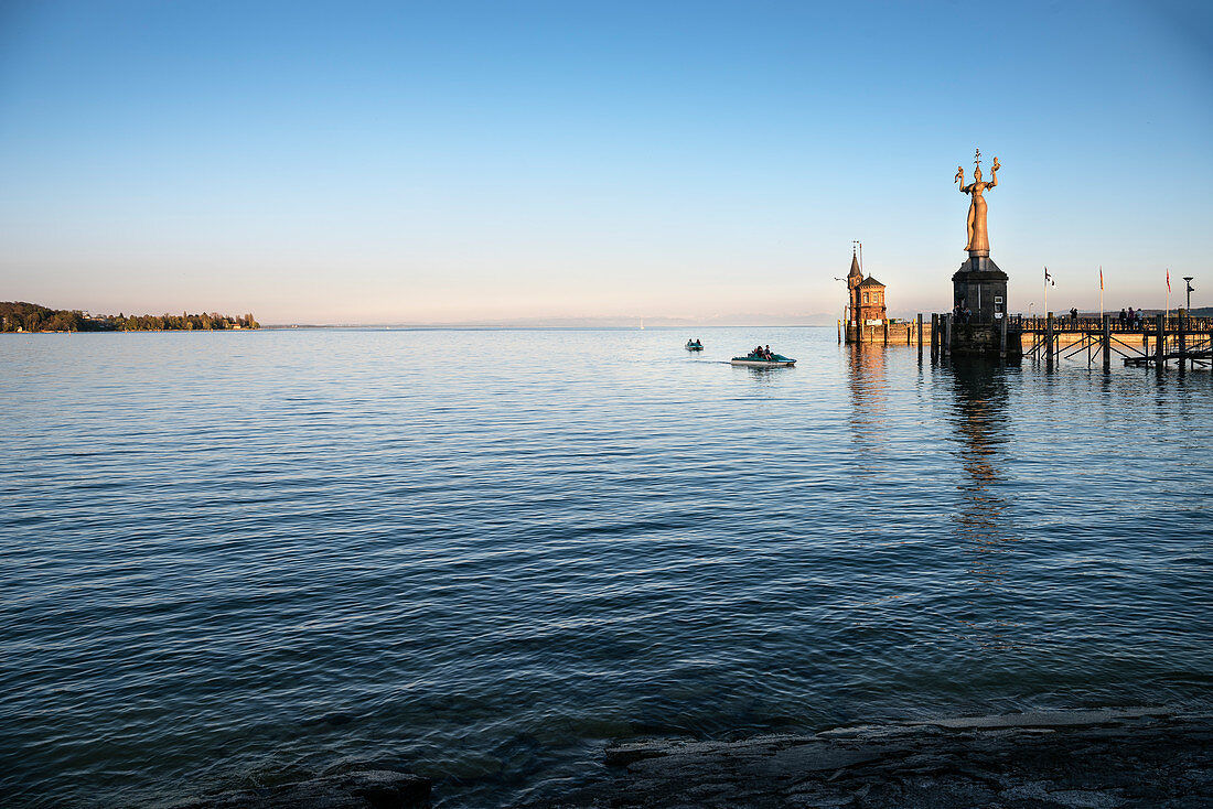 Pedal boat riders at the statue Imperia at Konstanz harbour, Lake Constance, Baden-Wuerttemberg, Germany