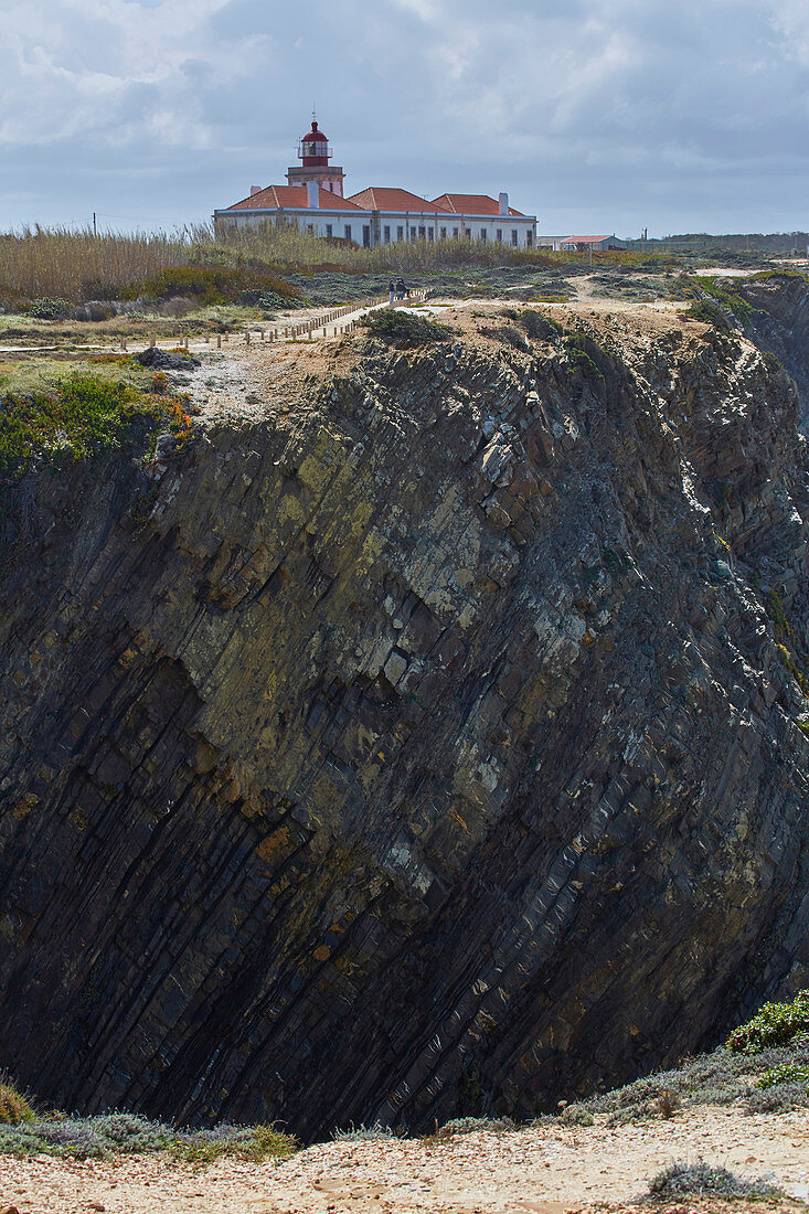 Steep coast and lighthouse at Cabo Sardao near Odemira, Parque Natural do Sudoeste Alentejano e Costa Vicentina, Southwest Alentejo and Vicentine Coast Natural Park, District Beja, Region of Alentejo, Portugal, Europe