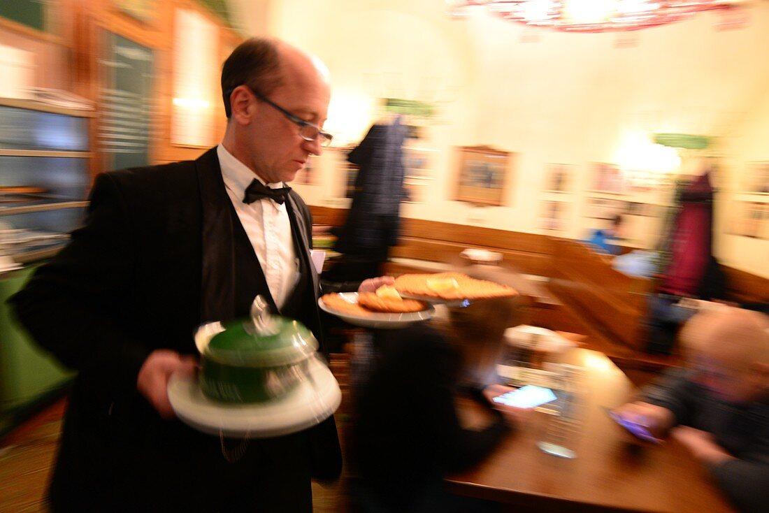 Ober served Riesenschnitzel in the restaurant Figlmüller, Vienna, Austria