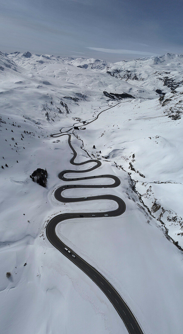View from above winding road through snow covered mountain, St. Moritz, Switzerland