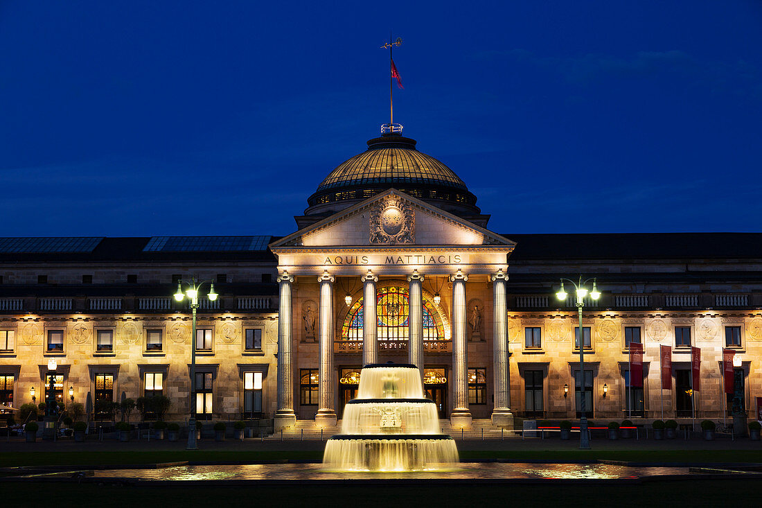 Illuminated fountain, at dusk, on the Bowling Green, in front of the Kurhaus, in Wiesbaden, Hesse, Germany, Europe