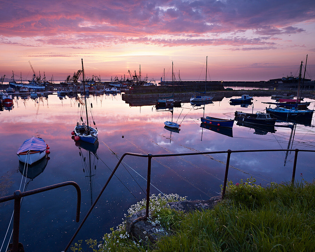 Spring twilight across the harbour of the fishing port of Newlyn, Cornwall, England, United Kingdom, Europe