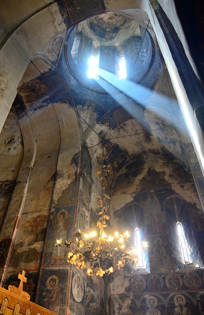 in the prayer room with rays of light and frescoes, the monastery of Gremi, Kakheti, Eastern Georgia