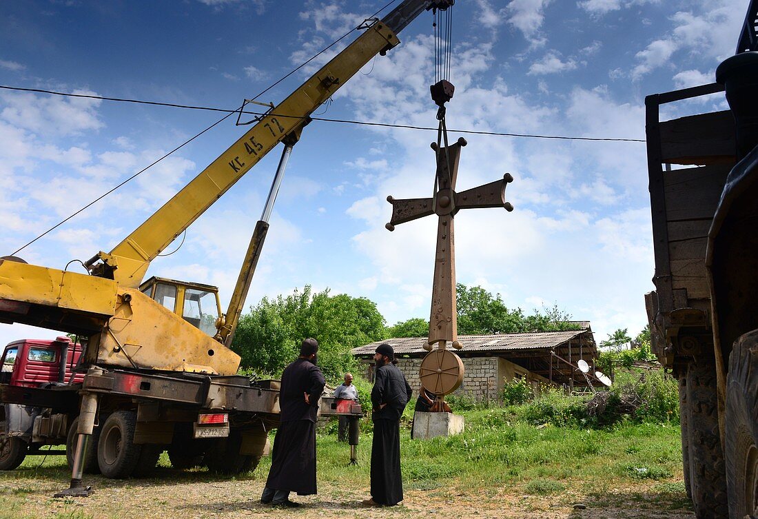Setting up a cross at Kitvisi Monastery near Gori, Georgia