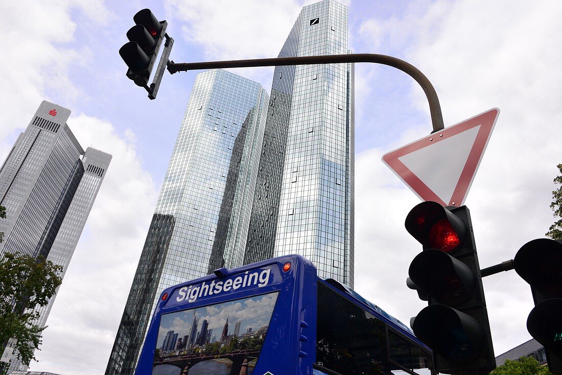 both buildings of Deutsche Bank in the financial district and sightseeing bus with traffic lights, Frankfurt, Hesse, Germany