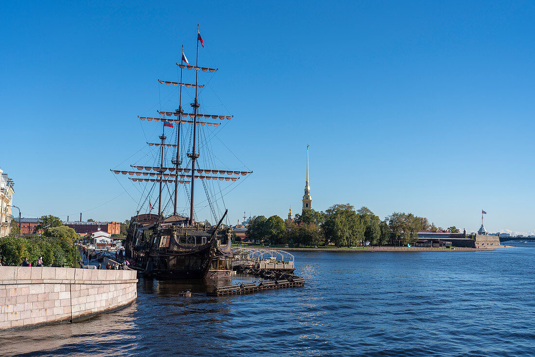 Old nautical vessel on Neva River with Peter and Paul fortress in the background. Saint Petersburg, Russia.