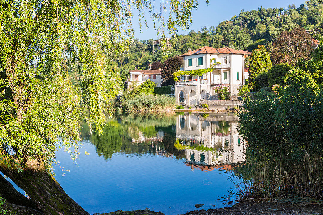 House reflected in the Pusiano lake, Como Province, Lombardy, Italy