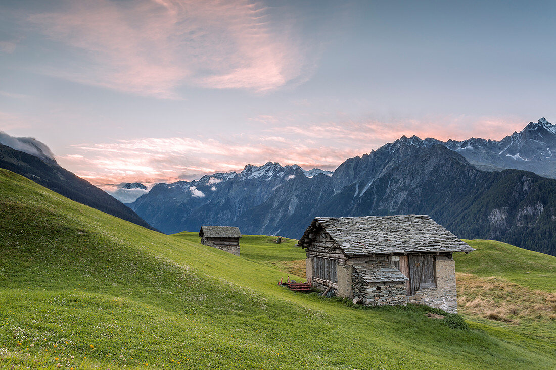 Alpine huts with snowy peaks in the background, Tombal, Soglio, Bregaglia Valley, canton of Graub?nden, Switzerland, Europe