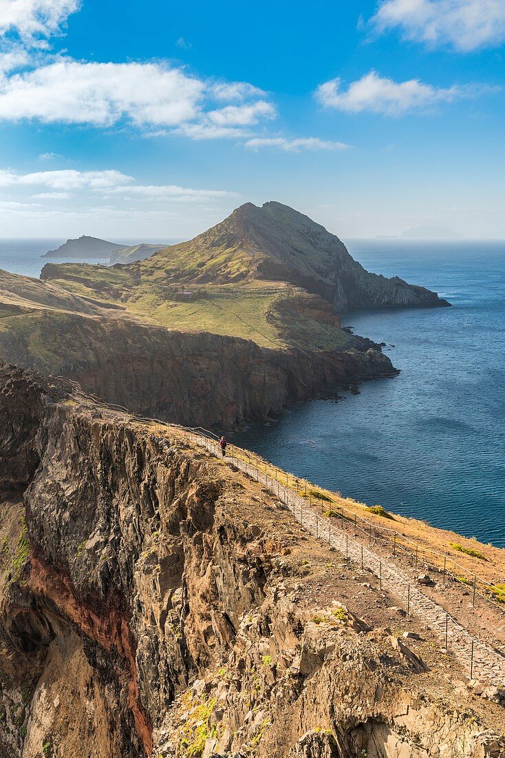 Hiker walking on the trail to Point of Saint Lawrence. Canical, Machico district, Madeira region, Portugal.