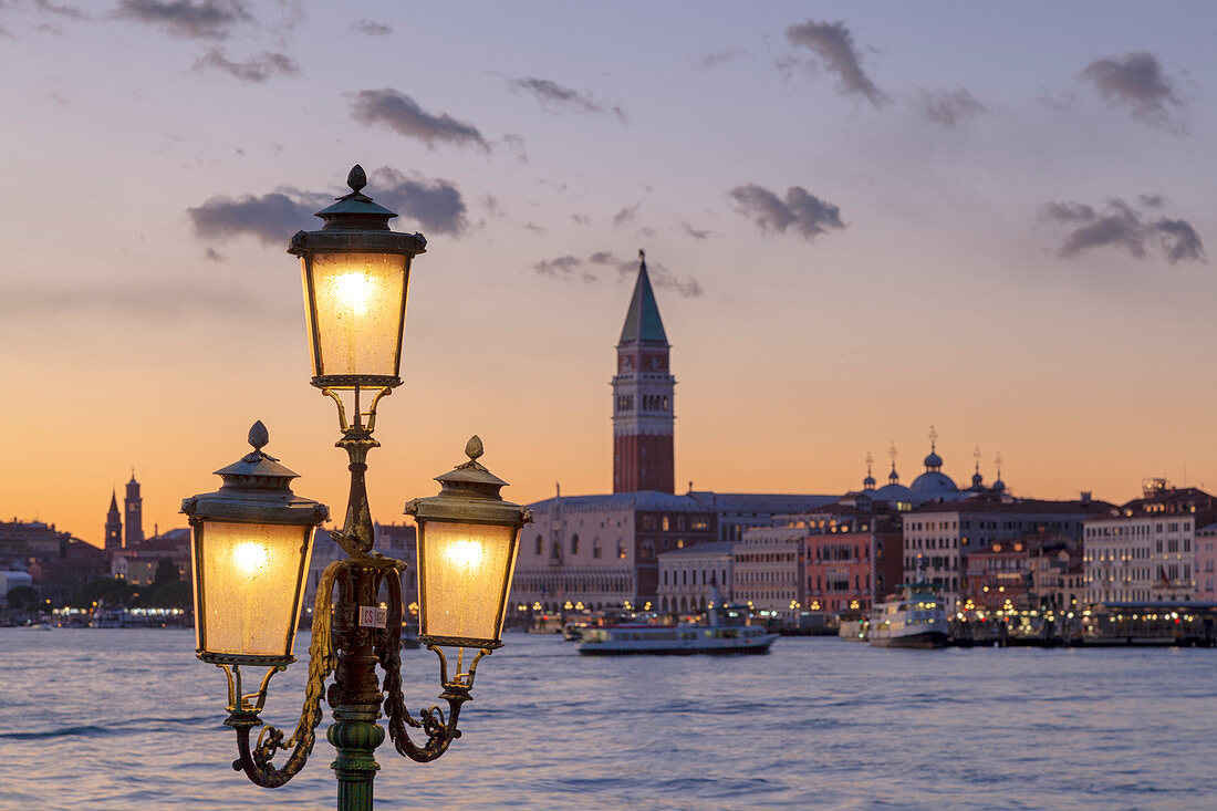 St. Mark's Campanile and Doge's Palace at sunset from Riva San Biasio at dusk, Venice, Veneto, Italy.
