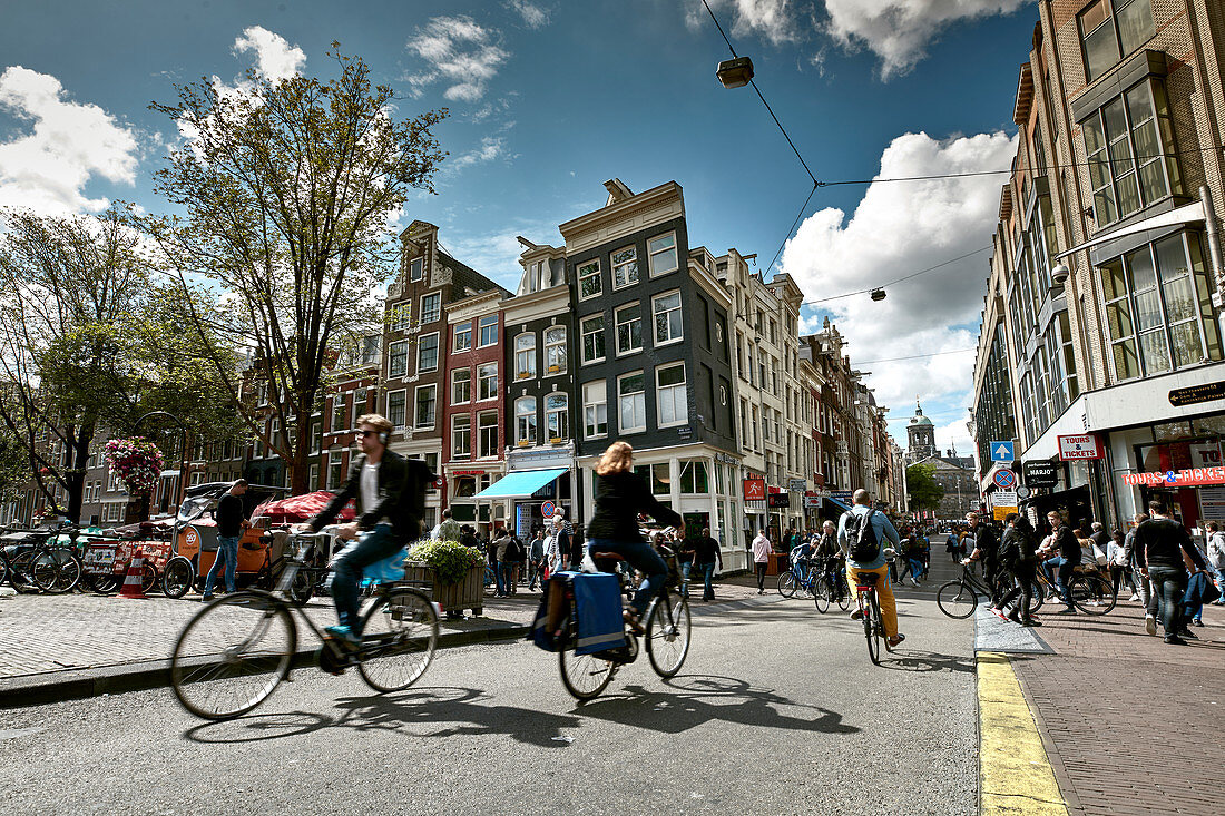 City life with cyclists in the center of Amsterdam, Netherlands