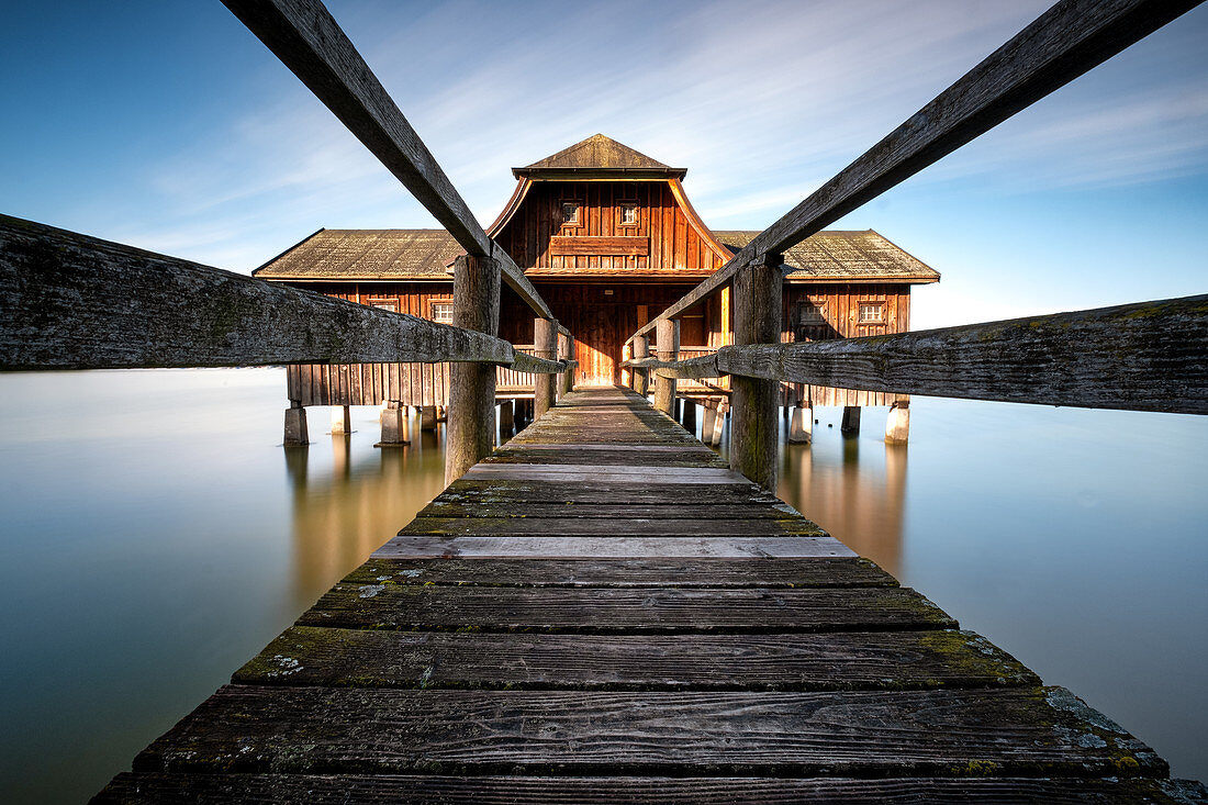 Badehaus Holzhütte from the jetty in the Ammersee standing at sunrise; Long Exposure; webs; ammersee; Foothills of the Alps; Bavaria; Germany