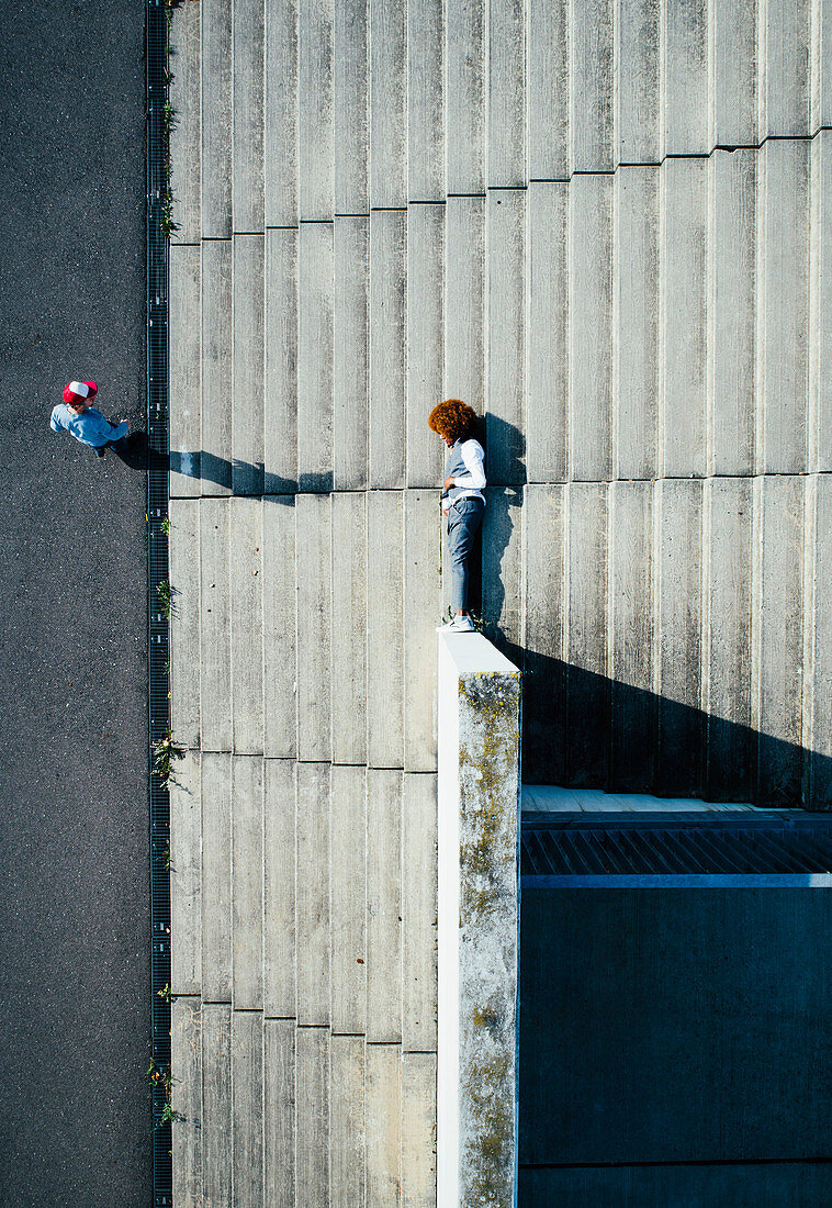 View from above young man laying on urban steps