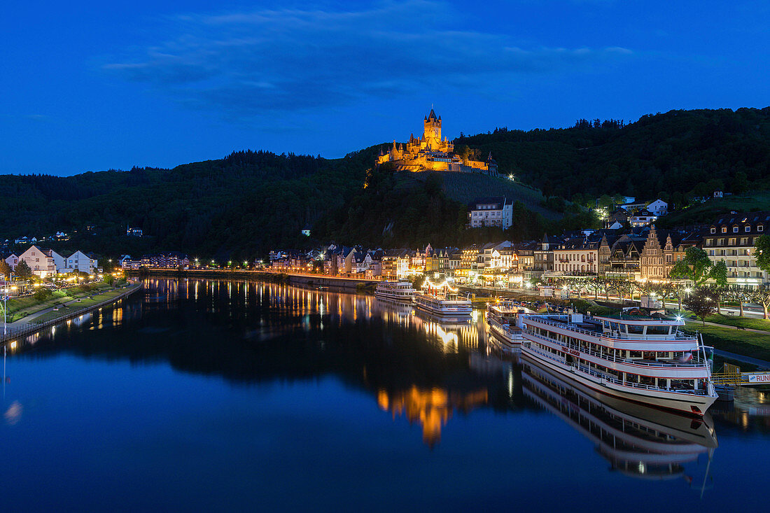 Town and Cochem Imperial Castle by river at sunset in Cochem, Germany