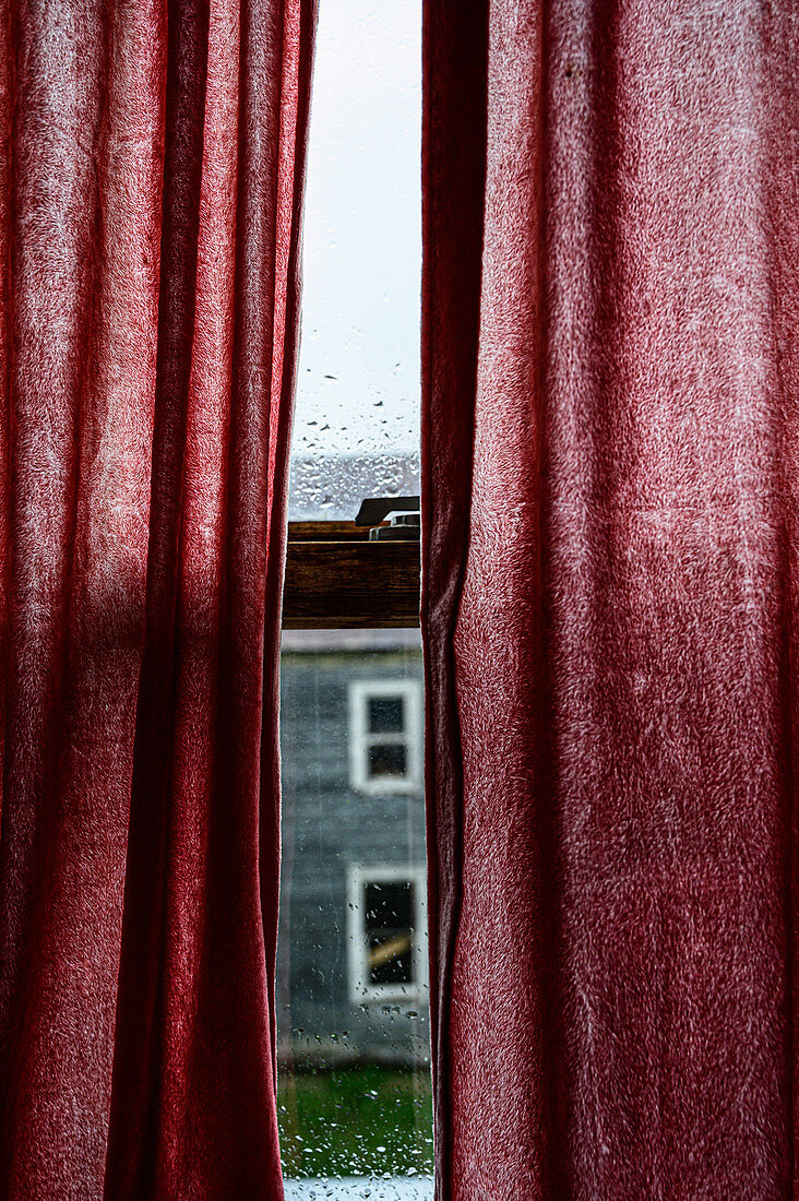 Red curtains over window