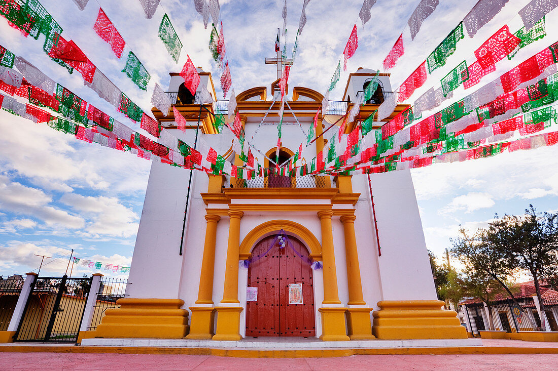 Red, white and green banners on church, Chiapas, Mexico