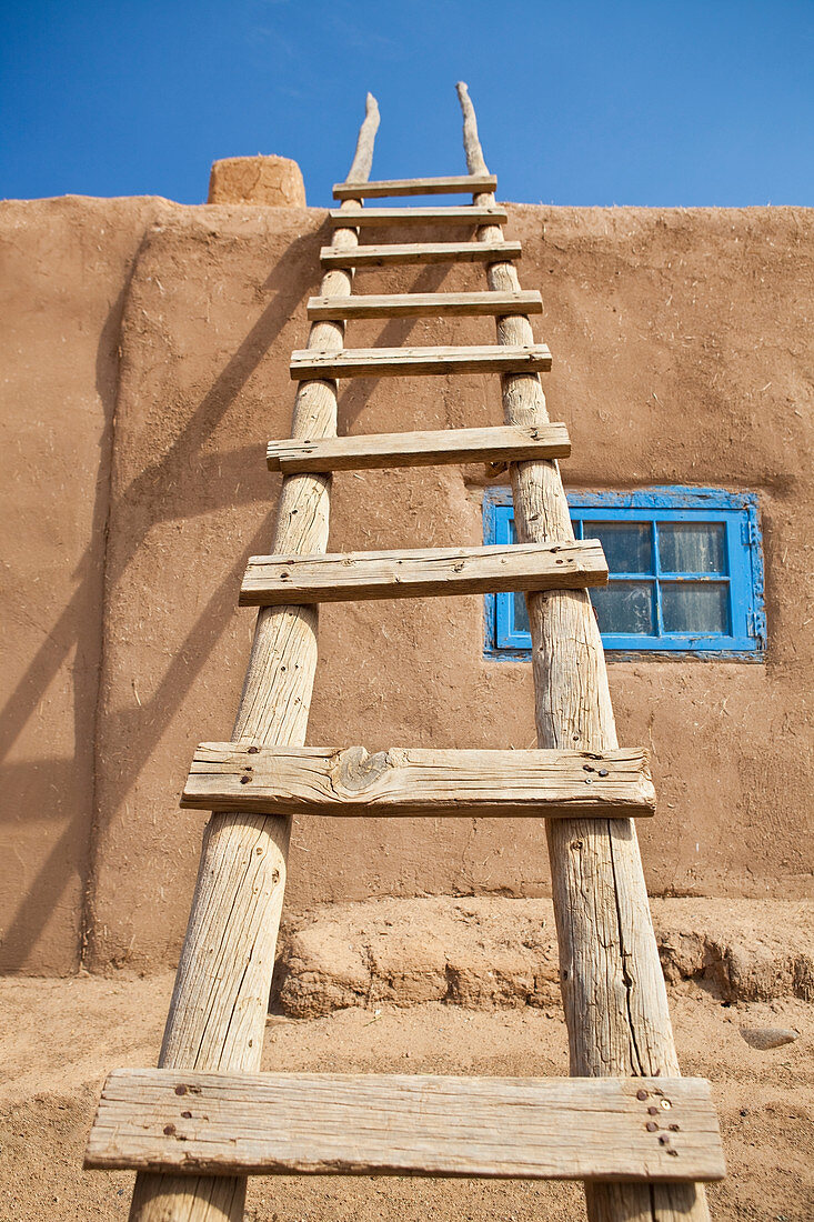 Wooden Ladder Against an Adobe Building,Taos, New Mexico, USA