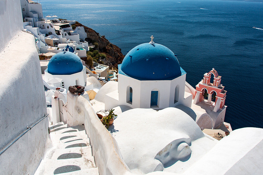 The blue domes and the pink chapel on Oia, Santorini, Greece