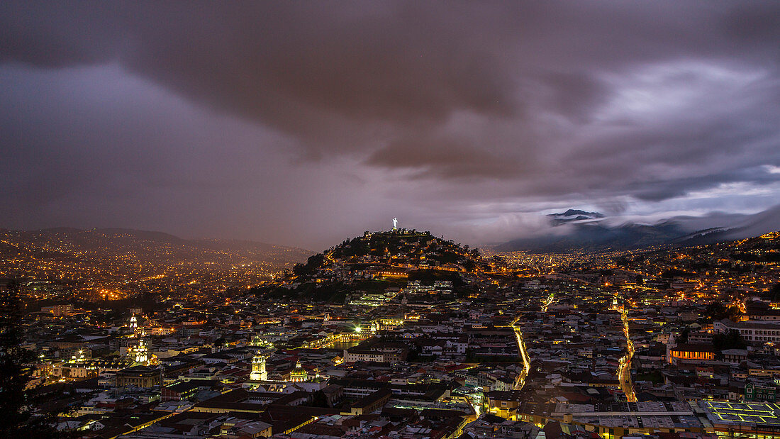 Quito, the capital of Ecuador at night. View of the lights of the city and the Panecillo