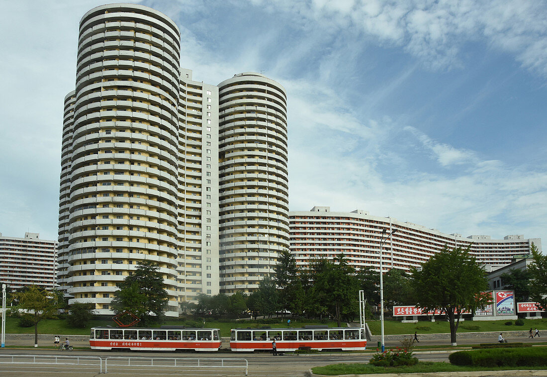 Tower blocks of flats beside urban tram, in centre of Pyongyang, North Korea, Asia