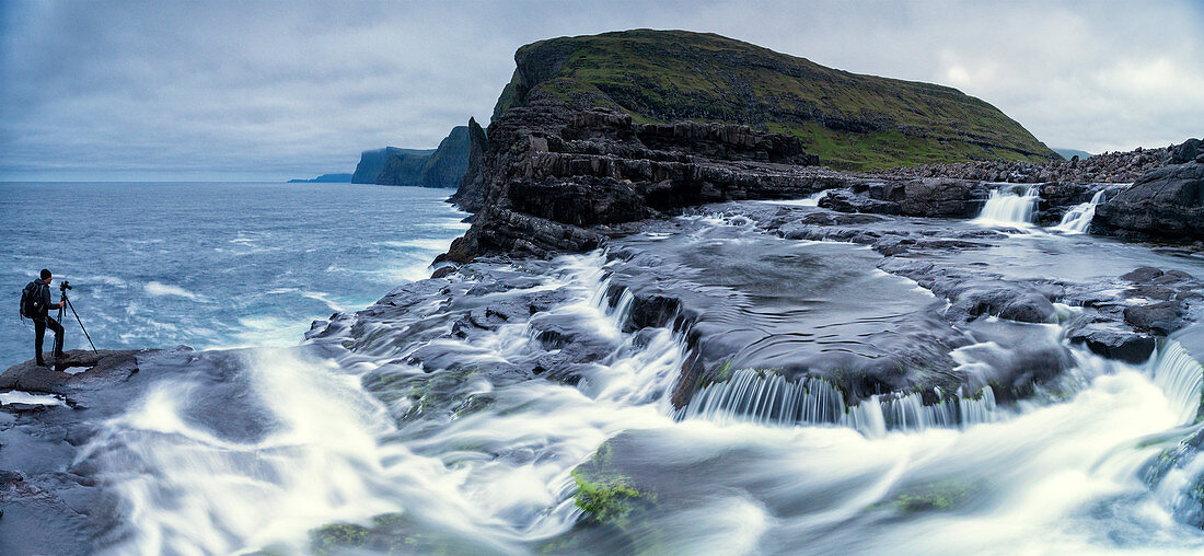 Panoramic of photographer at Bosdalafossur waterfall, Vagar island, Faroe Islands, Denmark, Europe