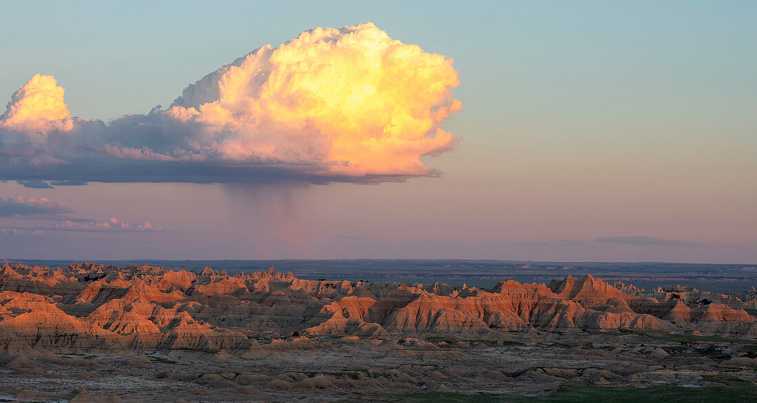 Clouds over rock formations of Badlands National Park at dusk, South Dakota, USA